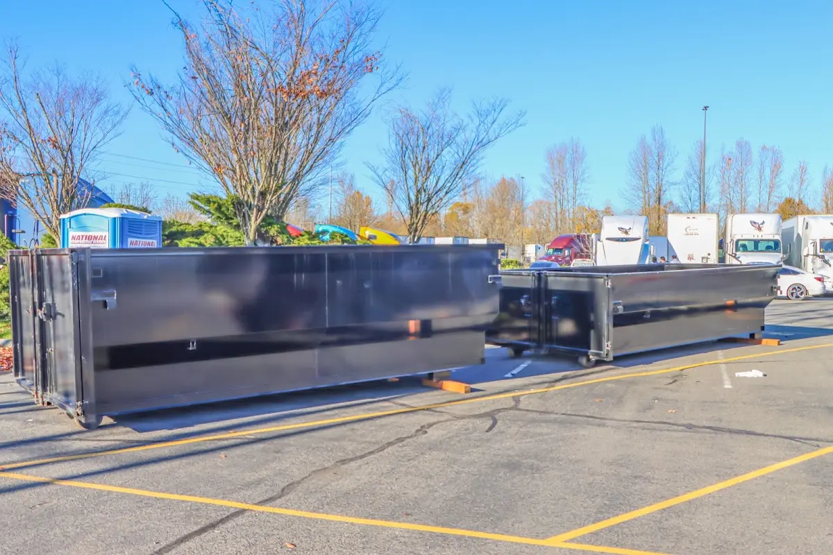 Professional dumpster rental service with roll-off container on residential driveway in Nicholasville